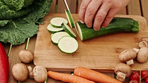 The process of cutting cucumbers. A man's hand holds a vegetable in his hands Stock Footage 201139877