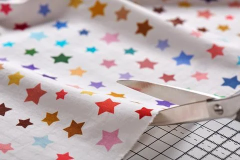 Process cutting fabric by scissors on craft mat Stock Photos