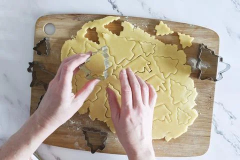 The process of cutting figures from shortcrust pastry for Christmas cookies Stock Photos