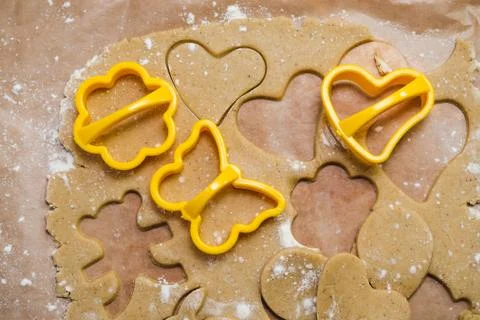 Process of cutting gingerbread in the shape of hearts, butterflies and flower Stock Photos
