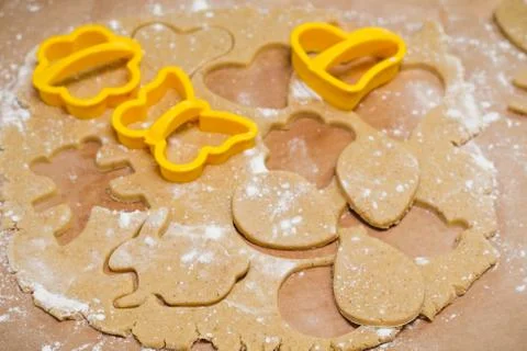 Process of cutting gingerbread in the shape of hearts, butterflies and flower Stock Photos