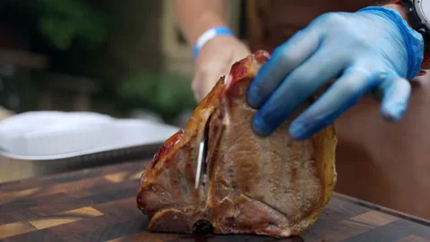 Process of cutting juicy roasted steak on cooking wooden board, chef separating Video stock 164388109