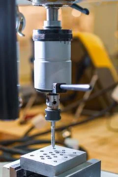The process of cutting a metric thread using a machine tap. Stock Photos