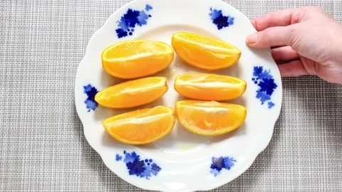 The process of cutting an orange into pieces. Stock Footage 152390812