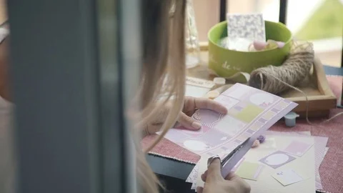 Process of cutting out paper from parts and elements for postcards. Stock Footage 79435893