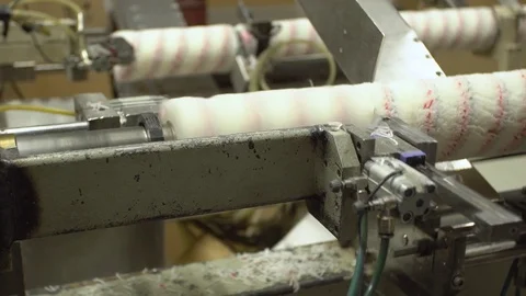 Process of cutting paint rollers for paint on a conveyor machine close-up 4k. Stock Footage