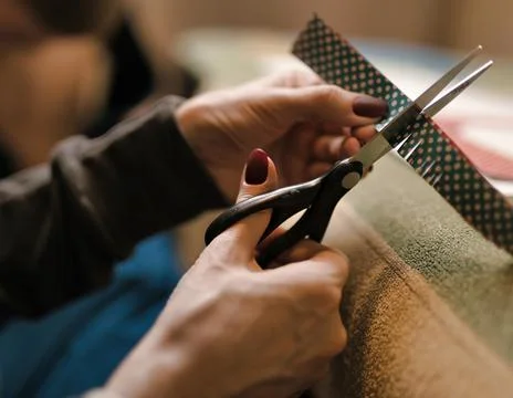 The process of cutting paper with scissors. scissors in female hands close-up Stock Photos