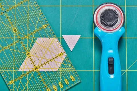 The process of cutting pieces of fabric in the shape of hexagons to create .. Fotos de archivo