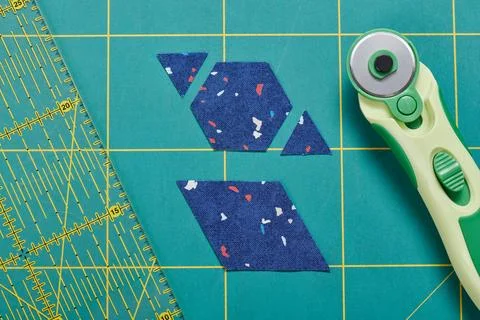 The process of cutting pieces of fabric in the shape of hexagons to create .. Stock-Fotos