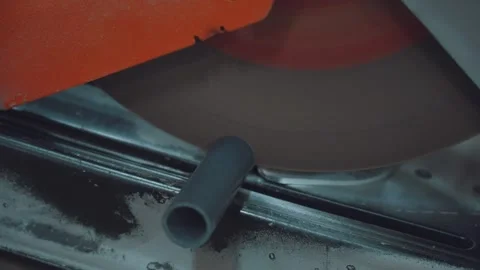 The process of cutting the pipe, the saw cuts the pipe Stock Footage 296348059