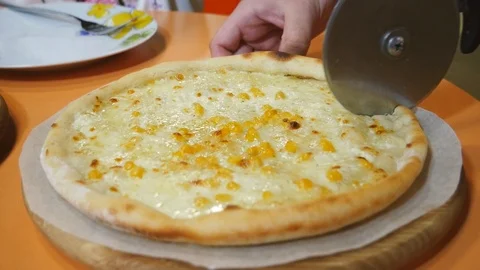 The process of cutting pizza on a wooden background Stock Footage 111566754