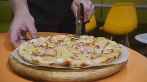 The process of cutting pizza on a wooden background Stock Footage 111566764