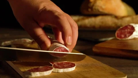 Process of cutting pork sausage with a knife. Stock Footage 169995764