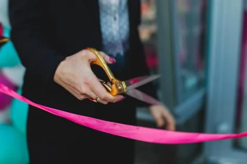 Process of cutting the red ribbon during the grand opening of the new shoppin Stock Photos
