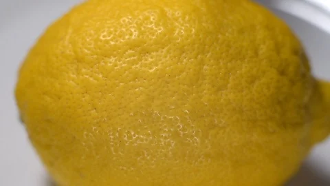 The process of cutting a ripe yellow lemon into two parts with a knife Stock Footage 125499959