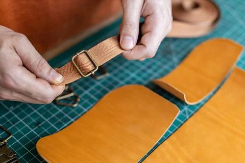 Process cutting scheme of bag with equipment and materials. Male tanner working Stock Photos