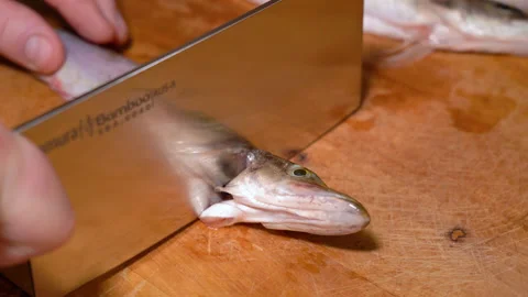 The process of cutting a small pike on a wooden board Видео 251005840