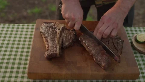 Process of cutting the steak. The juicy beef meat is cut into pieces. 스톡 동영상 265594191