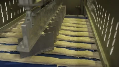 The process of cutting strips of dough into baguettes Stock Footage 170133127
