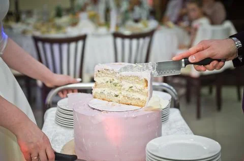 The process of cutting the wedding cake at the celebration 2237. Stock Photos