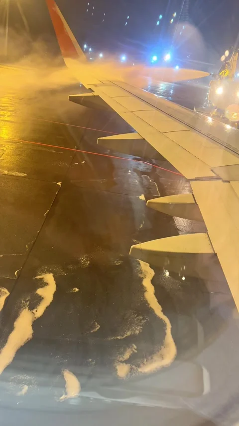 Process of de-icing the aircraft before the flying in the winter. Anti icing Stock Footage 265888958