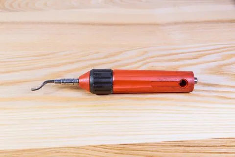 The process of deburring metal. Deburring tool for metal, wood, aluminum, cop Stock Photos