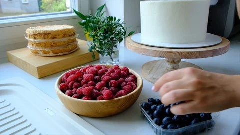 Process decorating berries cream cake. Stock Footage 113014739