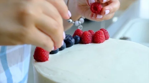 Process decorating berries cream cake. Stock Footage 113014877