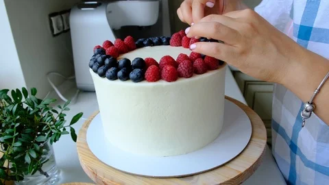Process decorating berries cream cake. Stock Footage 113015922
