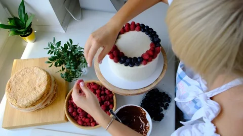 Process decorating berries cream cake. Stock Footage 113015938