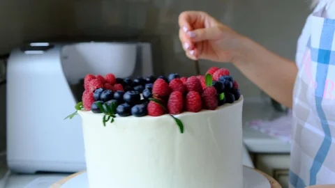 Process decorating berries cream cake. Stock Footage 113016350