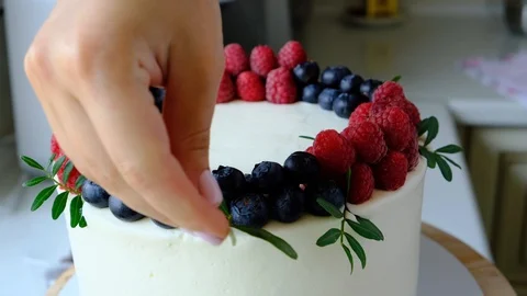 Process decorating berries cream cake. Stock Footage 113017145