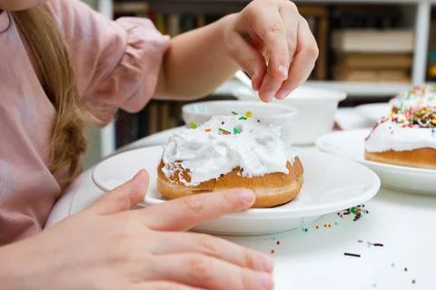 Process of decorating a cake with sweet colored decorations 写真素材