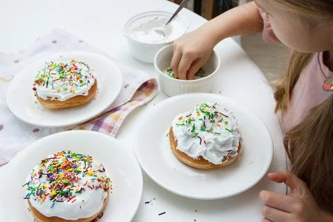 Process of decorating a cake with sweet colored decorations Stock Photos