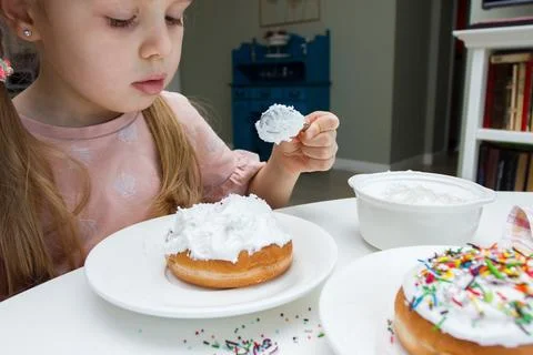 Process of decorating a cake with sweet colored decorations, concept of cooki Stock Photos
