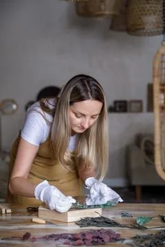 The process of decorating do it yourself. woman works with flowers in a small Stock Photos