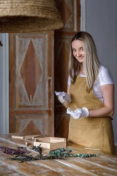 The process of decorating do it yourself. woman works with flowers in a small Stock Photos
