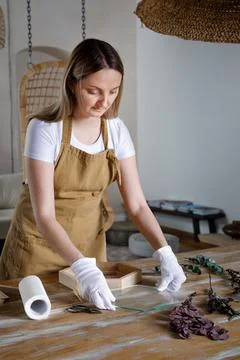 The process of decorating do it yourself. woman works with flowers in a small Stock Photos