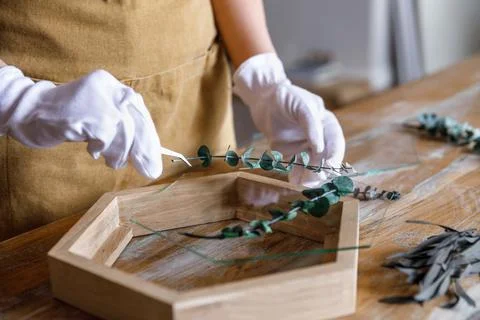 The process of decorating do it yourself. woman works with flowers in a small Stock Photos