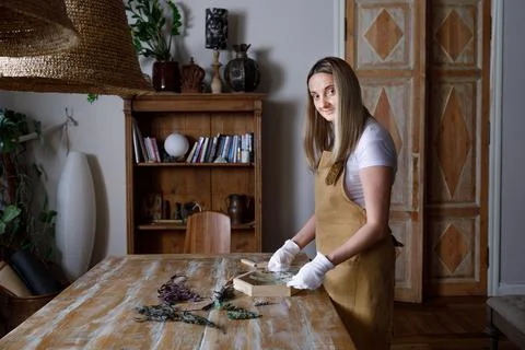 The process of decorating do it yourself. woman works with flowers in a small Stock Photos