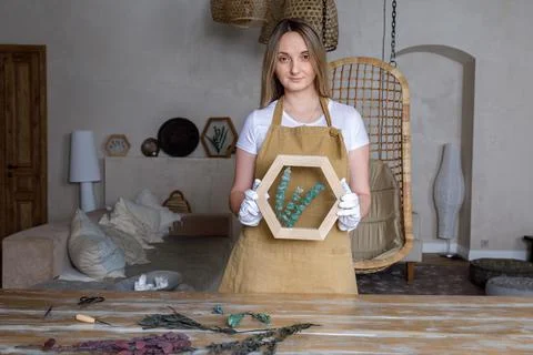The process of decorating do it yourself. woman works with flowers in a small Stock Photos