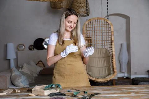 The process of decorating do it yourself. woman works with flowers in a small Stock Photos