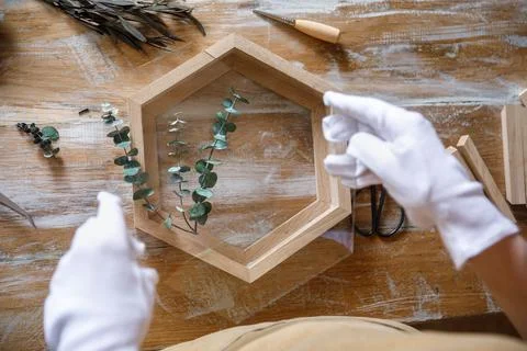 The process of decorating do it yourself. woman works with flowers in a small Stock Photos