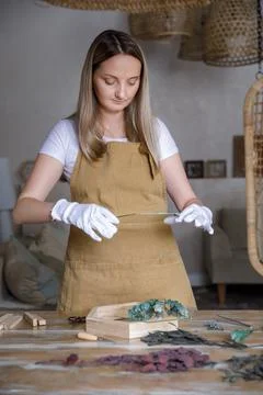 The process of decorating do it yourself. woman works with flowers in a small Stock Photos