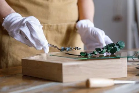 The process of decorating do it yourself. woman works with flowers in a small Stock Photos