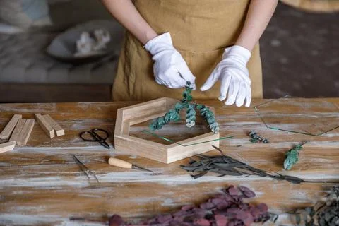 The process of decorating do it yourself. woman works with flowers in a small Stock Photos