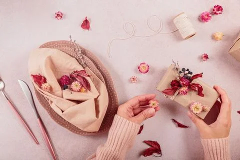 Process of decorating festive autumn table setting with dried flowers Stock Photos