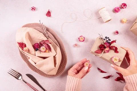 Process of decorating festive autumn table setting with dried flowers Stock Photos