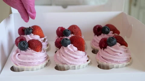 Process of decorating fruit cupcakes with chocolate chips. Stock Footage 135609409