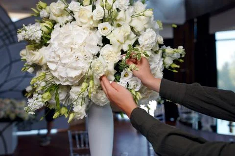 The process of decorating a large bouquet of white roses Stock Photos